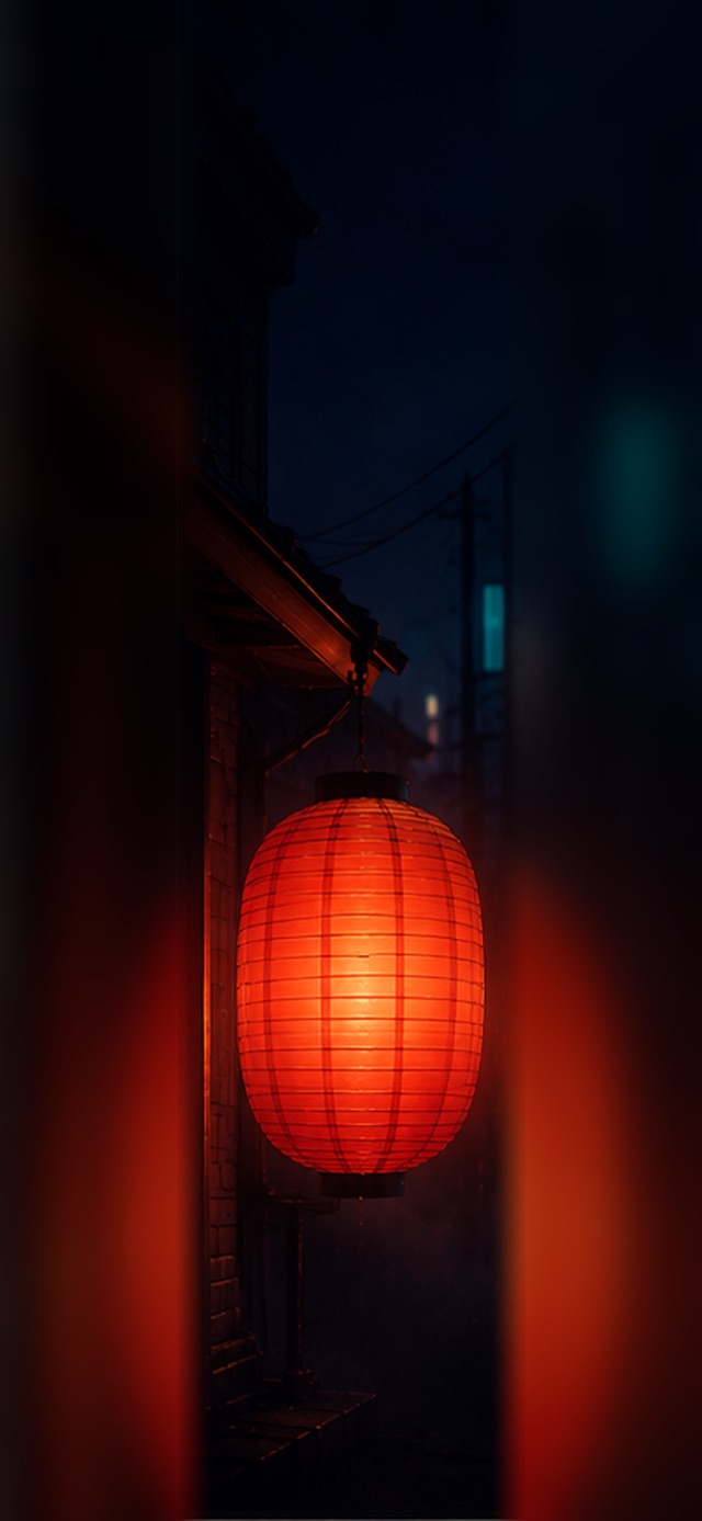 Large glowing red-orange Japanese paper lantern hanging from dark wooden eaves at night